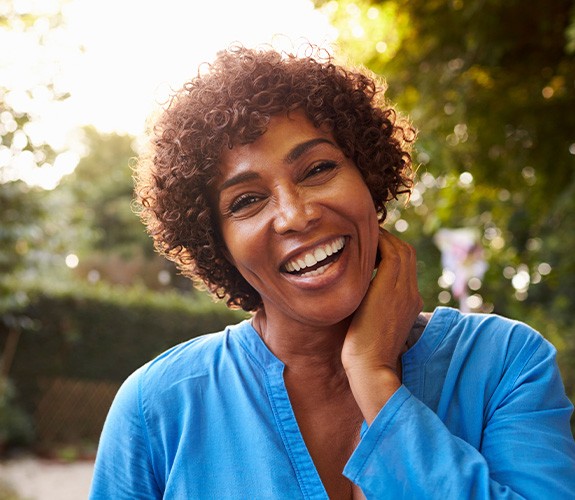 Middle-aged woman smiling with dental implants in Channahon
