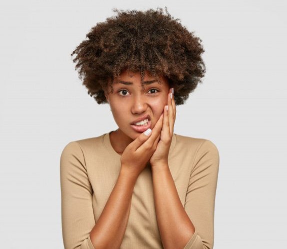 Woman experiencing slight mouth pain