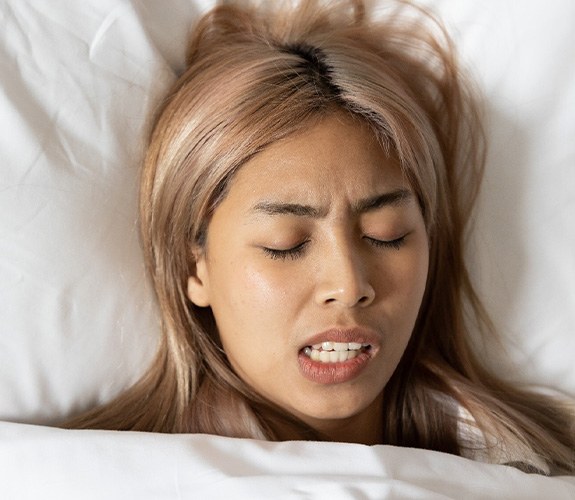 Person grinding their teeth at night