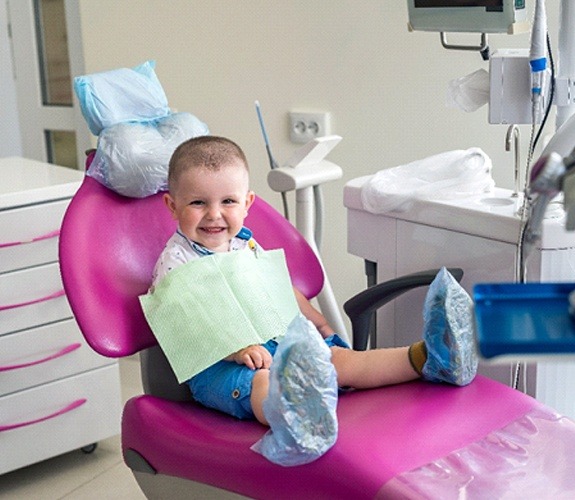Mother holding child who is brushing their teeth