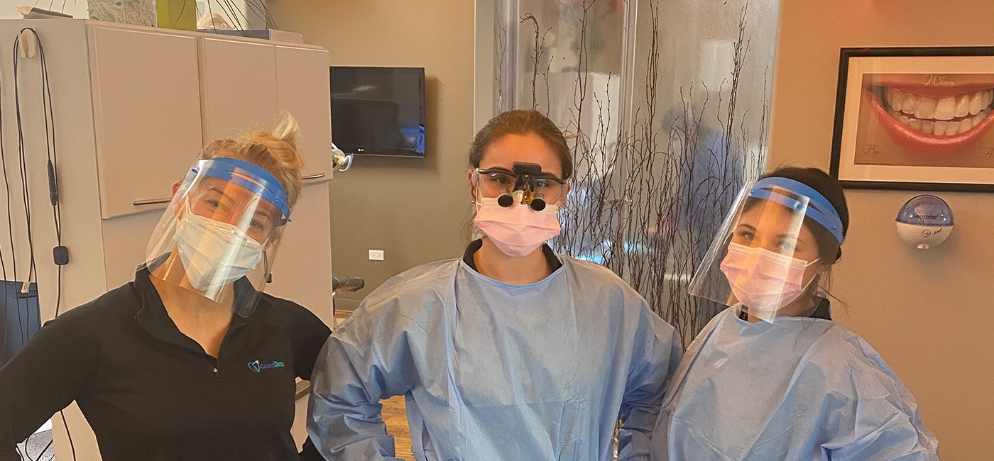 Two dental team members in protective equipment