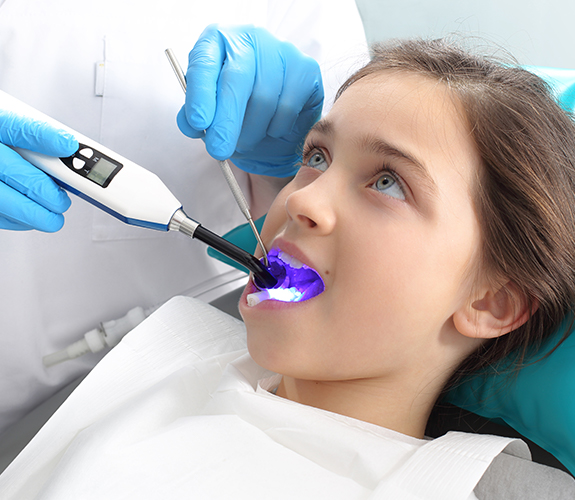 Child receiving dental sealants