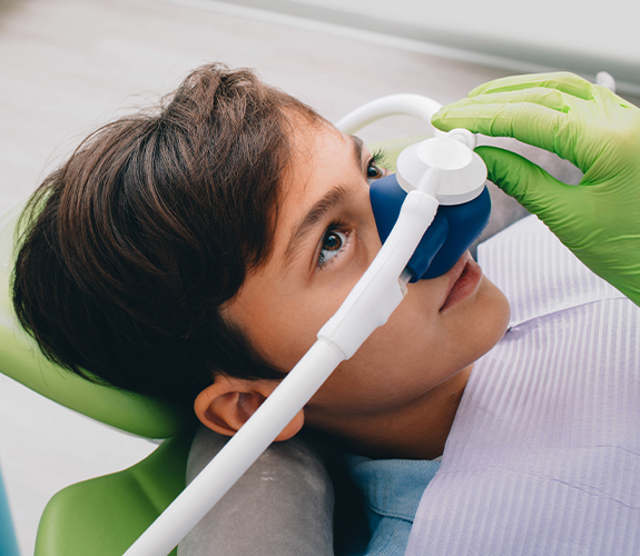 Child receiving nitrous oxide sedation dentistry treatment