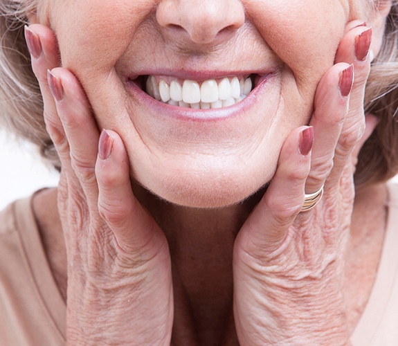 Woman smiling after cost of dentures in Channahon
