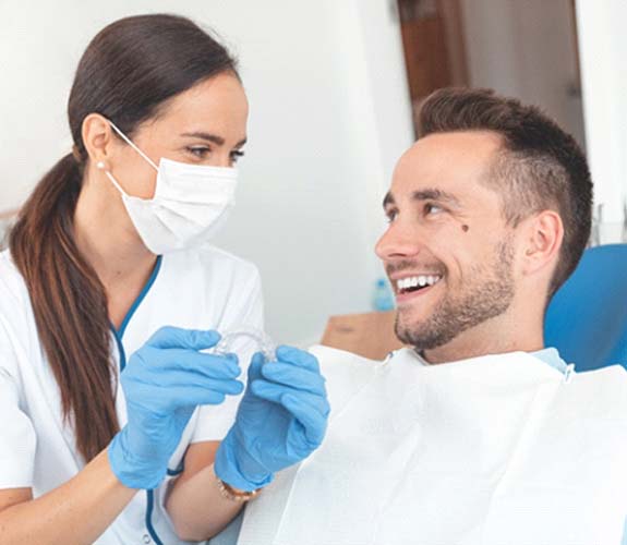 dentist and patient discussing cost of Clear Aligners in Channahon
