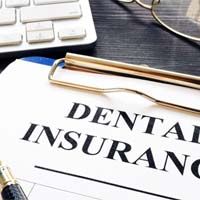 Closeup of dental insurance paperwork for the cost of Clear Aligners in Channahon