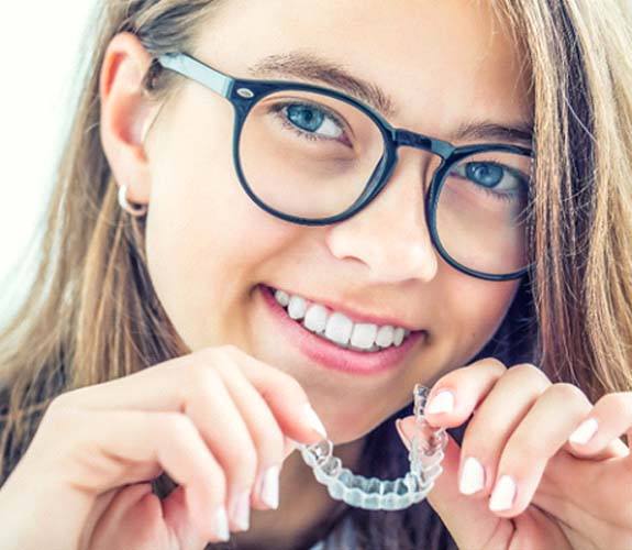 Girl inserting Invisalign Teen in Channahon