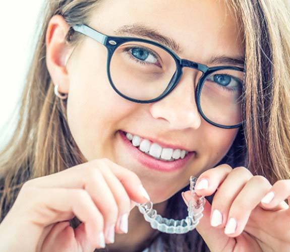 Girl inserting Clear Aligners Teen in Channahon