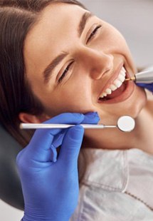 a patient smiling during her dental checkup