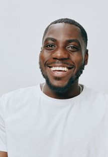 a man smiling with very bright teeth