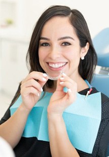 a patient holding onto clear aligners