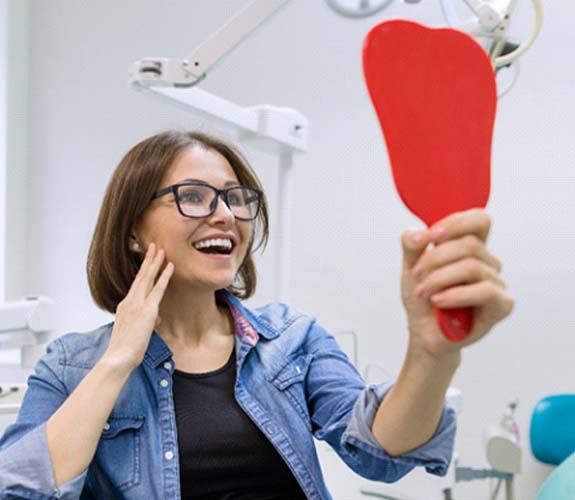 Woman admiring her new metal-free fillings in Channahon