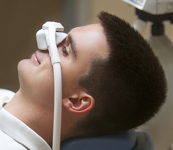 Man with nitrous oxide dental sedation mask in place