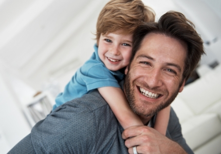 Father and son smiling after children's dentistry