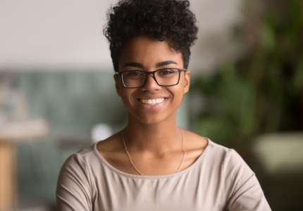 Young woman with healthy smile after orthodontics