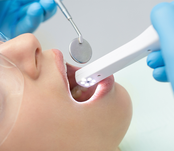 Dentist using intraoral camera to capture smile images