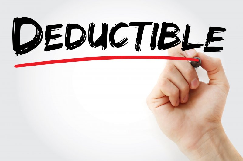 person writing the word deductible