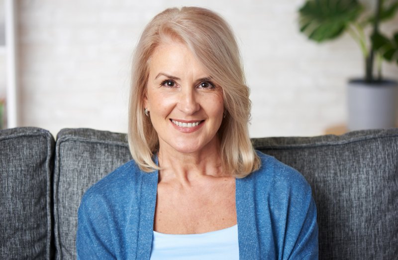 older woman sitting on the couch and smiling